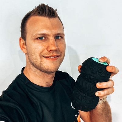 Man holding a black textured roller against a white background