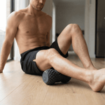 Man using a vibit roller on a wooden floor