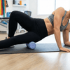 Person using a vibit roller on a mat in a home setting