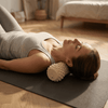 Woman using a vibit roller on a yoga mat in a bedroom setting